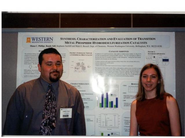 andy Self and Diana Phillips standing in front of poster at ACS