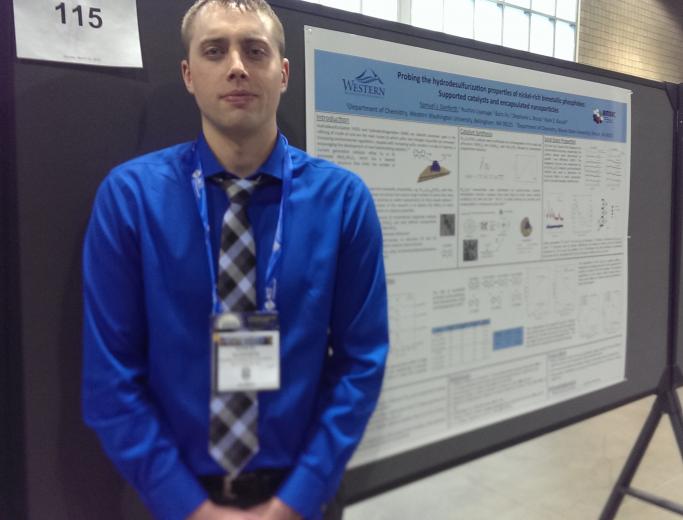 Student in front of poster at conference