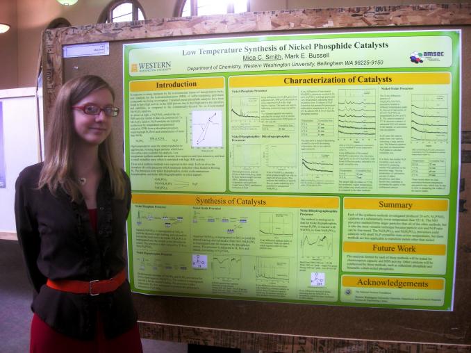 Scholars week student stands in front of poster