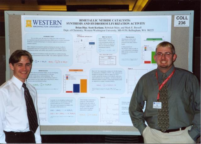 Scott Korlann and Brian Diaz standing in front of poster at ACS