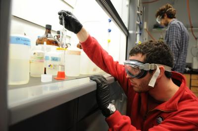 Student in lab holding glassware