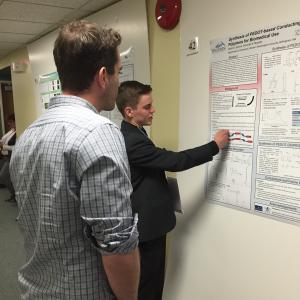 Student presenting research poster