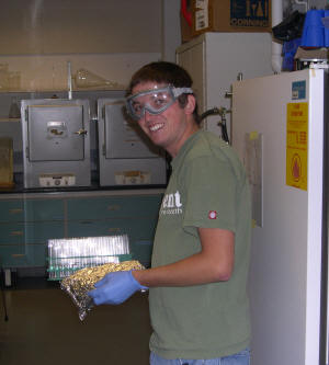Student with protective eye gear in research lab