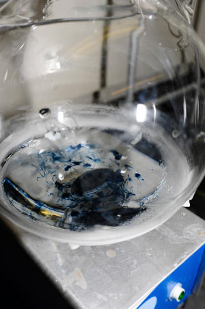 blue residue at the bottom of a beaker