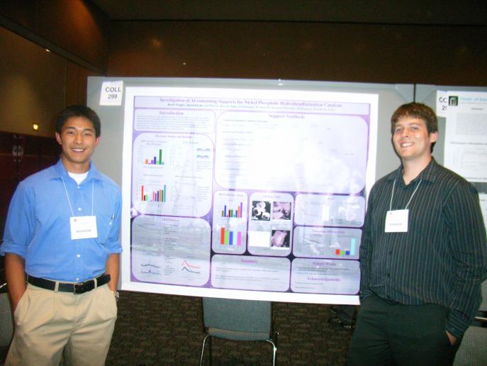 Junwen Law and Jake Yeager standing in front of poster at conference