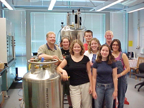 group of students standing by cylinder 